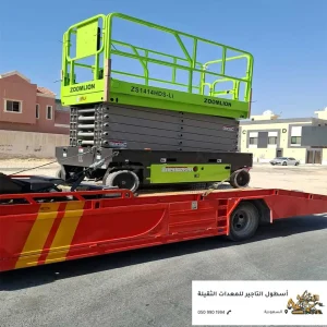 سيزرلفت أخضر على سطحة لنقل المعدات